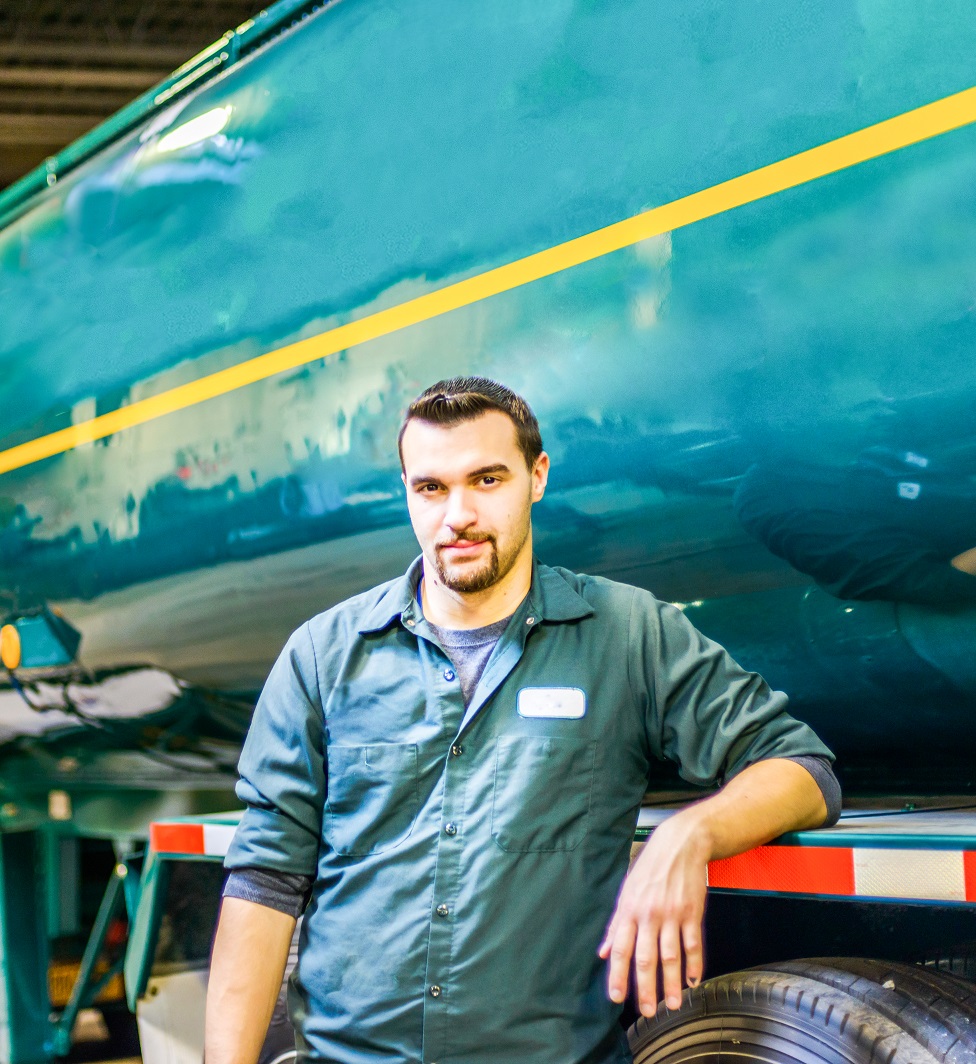 Portrait of young male trucker at biofuel industrial plant Portrait of young male trucker at biofuel industrial plant