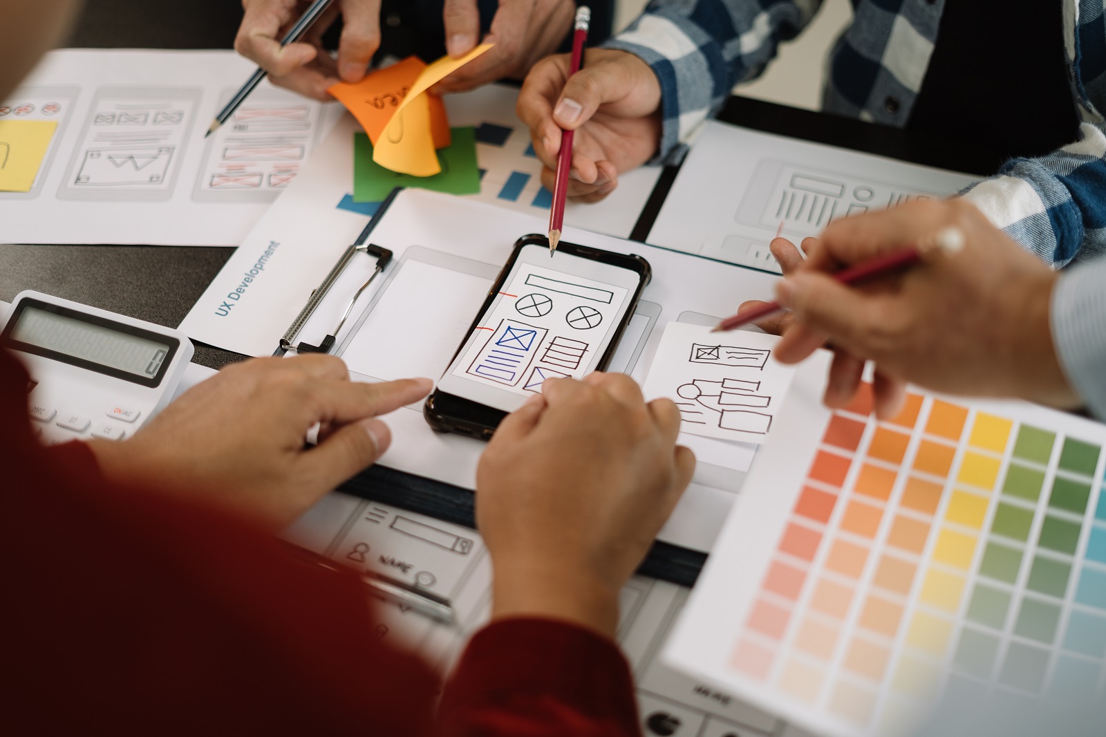 Creative male web designer planning application development for Creative male web designer planning application development for web mobile phone at modern workplace.